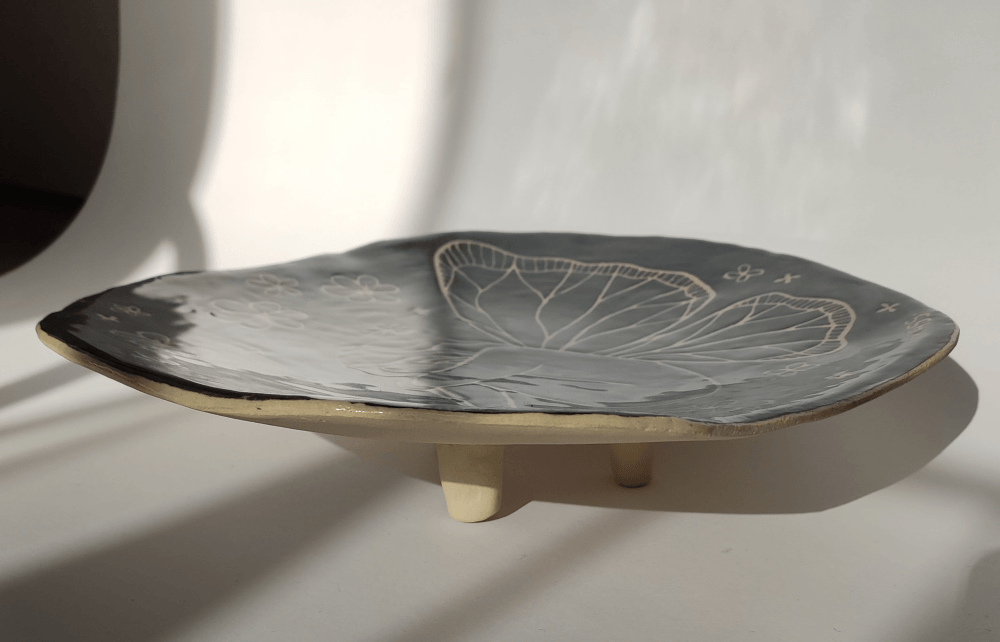 Transformation ceramic platter side view showing one foot and an approximate height of 6 cm