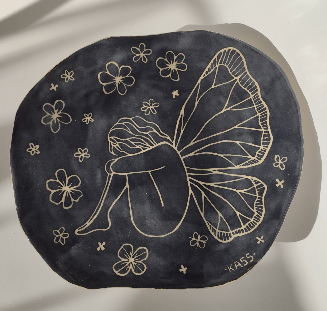 Transformation ceramic platter top view with sgraffito illustration and floral motifs